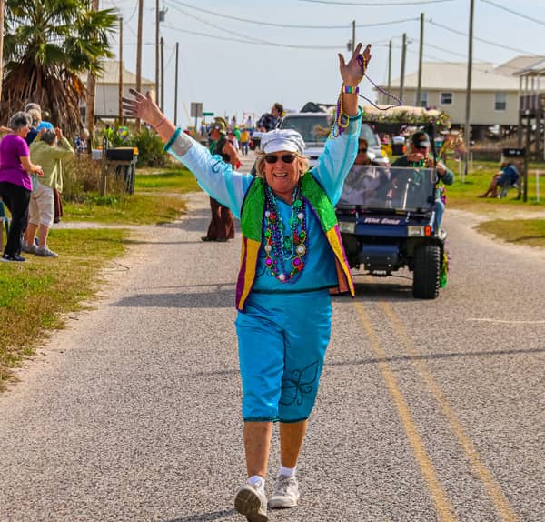 Lady posing in Fort Morgan parade with hands up.